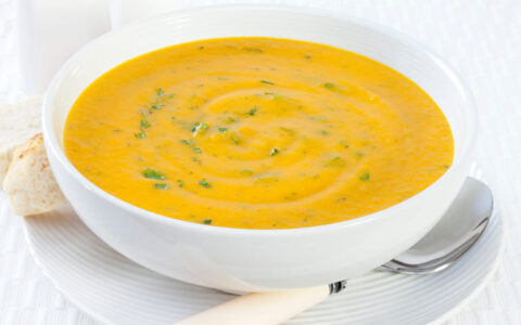 potage à la courge musquée dans bol blanc et cuillère