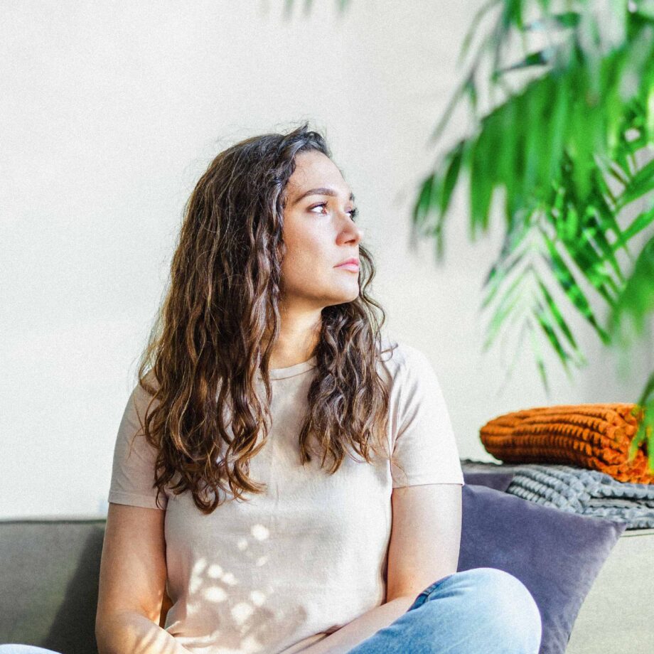 femme pensive assise sur un divan
